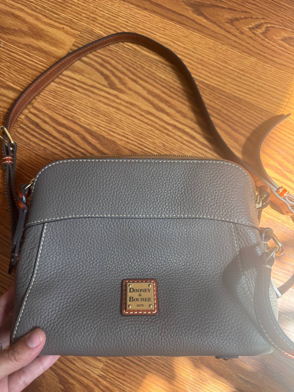 Dooney & Bourke bag with logo and adjustable leather strap